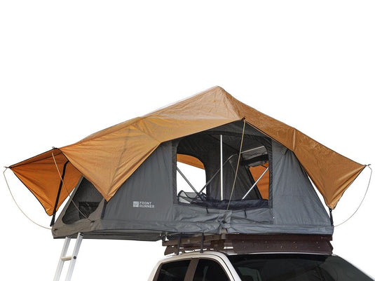 Front Runner Roof Top Tent mounted on vehicle with open windows and awning for outdoor camping
