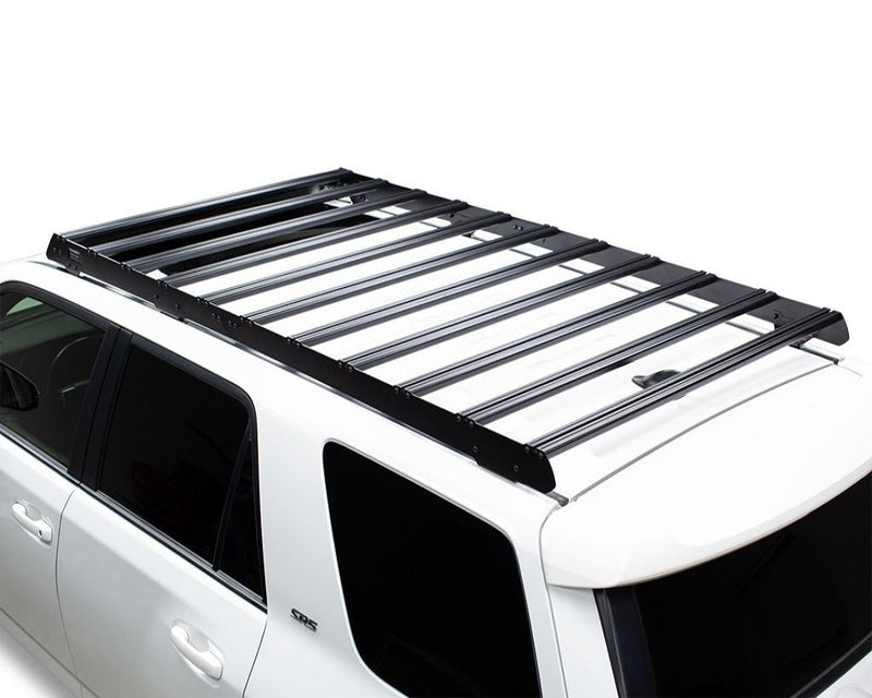 Load image into Gallery viewer, Front Runner Slimsport Roof Rack Kit mounted on white Toyota 4Runner (2010-Current), streamlined design for outdoor adventure gear storage.
