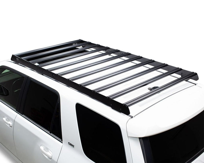 Load image into Gallery viewer, Front Runner Slimsport Roof Rack Kit mounted on white Toyota 4Runner (2010-Current), streamlined design for outdoor adventure gear storage.