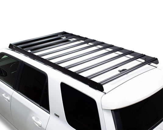 Front Runner Slimsport Roof Rack Kit mounted on white Toyota 4Runner (2010-Current), streamlined design for outdoor adventure gear storage.