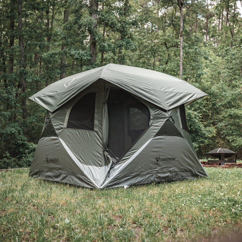 Load image into Gallery viewer, Gazelle Tents T4 Hub Tent set up in a forest clearing, showcasing its quick pop up design and spacious interior.
