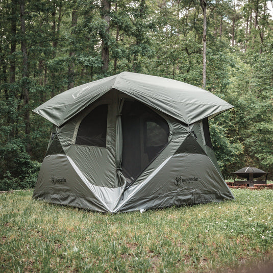 Gazelle Tents T4 Hub Tent set up in a forest clearing, showcasing its quick pop up design and spacious interior.