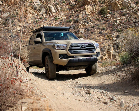 Toyota Tacoma with Front Runner Slimline II Roof Rack on rocky terrain