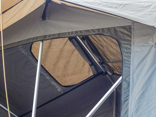Close-up view of a Front Runner Roof Top Tent with open window showing durable fabric and sturdy frame.