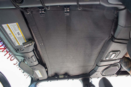 Fishbone Offroad rear sun shade installed in Jeep Wrangler Unlimited JLU, interior view showing mesh sunshade blocking sunlight.