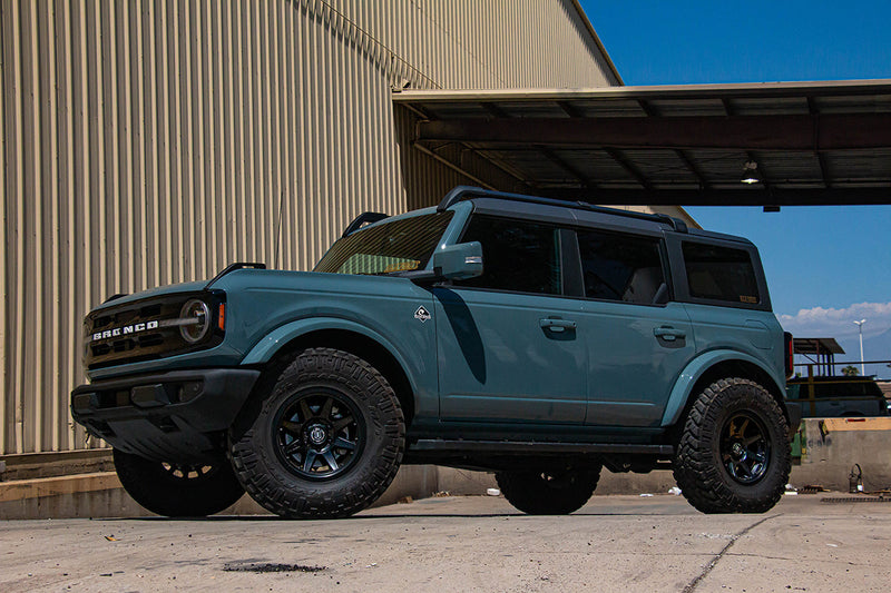 Load image into Gallery viewer, ICON Vehicle Dynamics Rebound PRO Satin Black wheels on a blue Ford Bronco