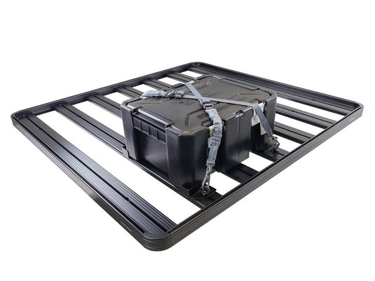 Alt text: inchFront Runner Adjustable Rack Cargo Chocks securing a storage box on vehicle roof rackinch