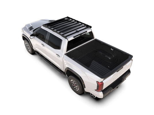 Alt text: inch2022 Toyota Tundra Crew Cab equipped with Front Runner Slimsport Roof Rack Kit, showcasing the sleek design and cargo space enhancement on a white truck from a high angle view.inch