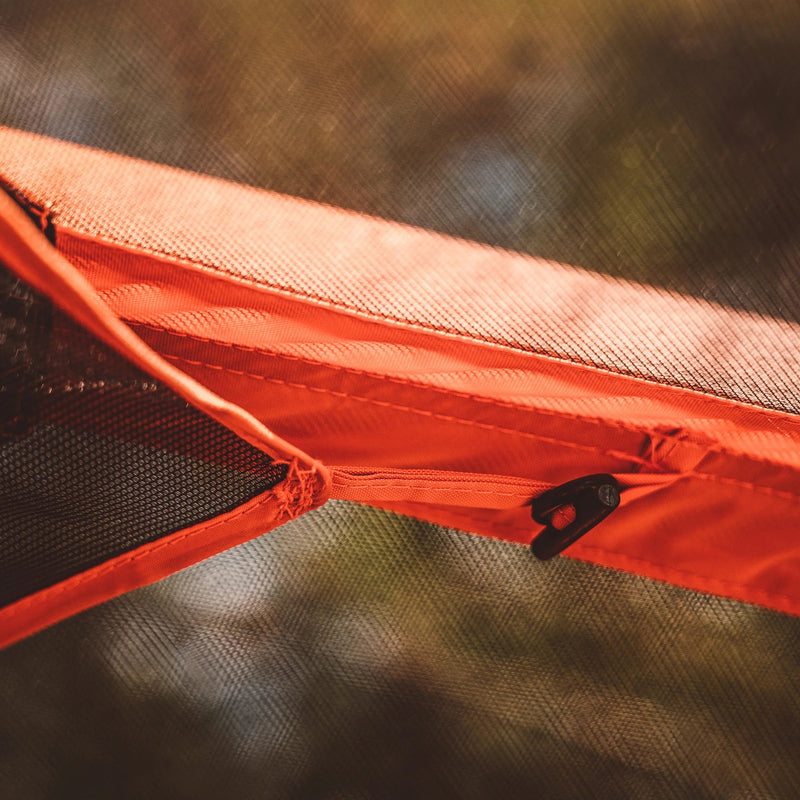 Load image into Gallery viewer, Close-up view of the orange fabric and zipper detail on Gazelle Tents T4 Hub Tent.
