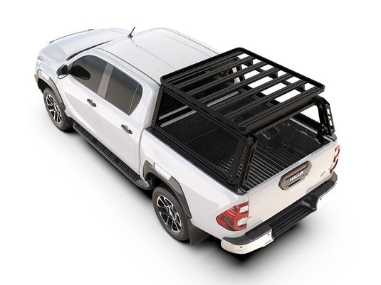 Alt text: inchWhite Toyota Hilux Revo Double Cab 2016 with Front Runner Pro Bed Rack Kit installed on truck bed for additional storage spaceinch