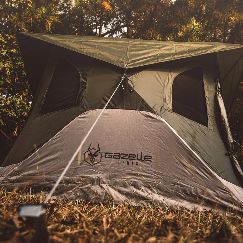 Load image into Gallery viewer, Gazelle Tents T4 Hub Tent set up in a forested area, showcasing the durable material and spacious design.
