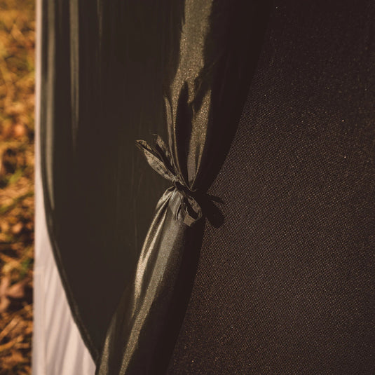 Close-up view of a Gazelle T4 Hub Tent fabric with tie-back detail for ventilation during camping.