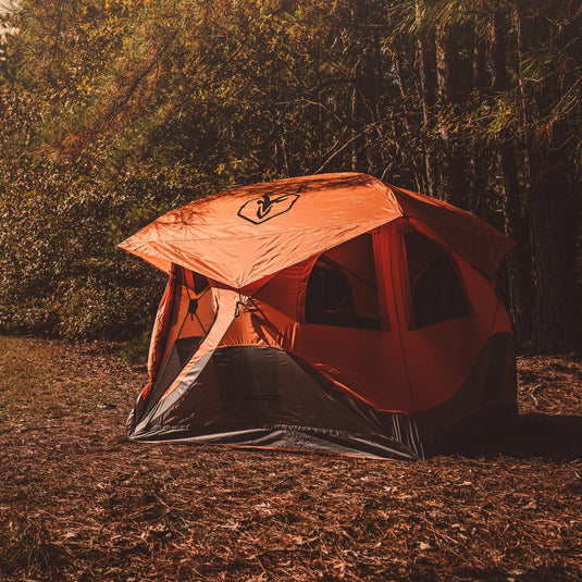 Gazelle Tents T4 Hub Tent set up in a wooded area during autumn.
