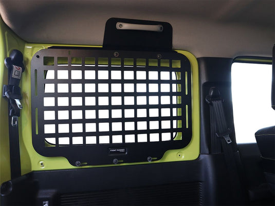 Alt text: inchFront Runner Suzuki Jimny 3 Door 2018-Current Rear Window Molle Panel installed in a vehicle, offering organized storage solution.inch
