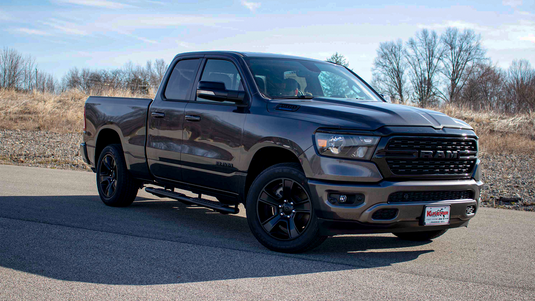 Alt text: inch2019 Ram 1500 Quad Cab with Fishbone Offroad 5-inch oval side steps installed, parked outdoors.inch