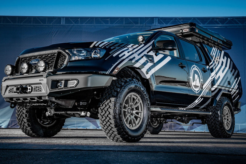 Load image into Gallery viewer, Customized off-road vehicle featuring ICON Vehicle Dynamics Vector 6 wheels in bronze, equipped with extra lighting and roof rack
