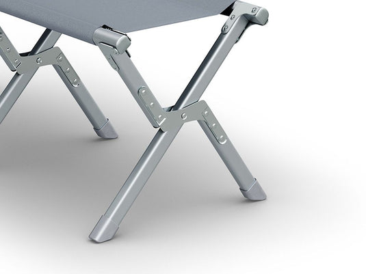 Alt text: "Close-up of the sturdy aluminum legs and frame of the 'Front Runner Dometic Go Compact Camp Bench' in a silt grey color, demonstrating the bench's portable design and durable construction for outdoor use."