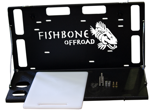 Alt text: "Fishbone Offroad tailgate table for Jeep Wrangler JK, JKU, JL, JLU models and Ford Bronco 2021-current, with logo and mounting hardware."