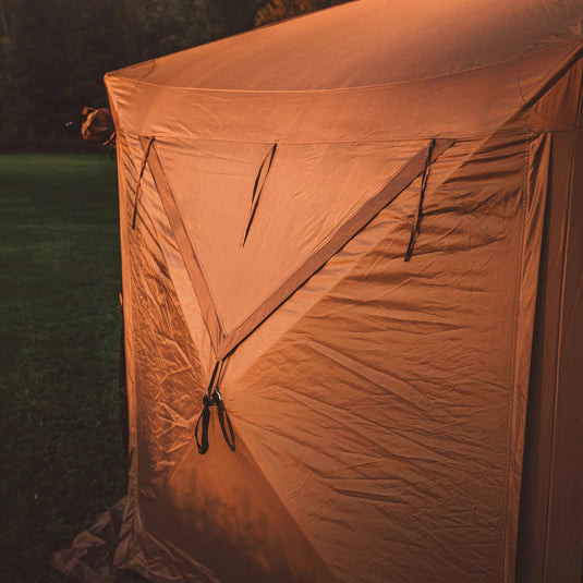 Gazelle Tents G6 Deluxe 6-Sided Portable Gazebo set up in a field at dusk.