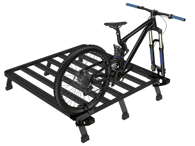 Load image into Gallery viewer, Front Runner Load Bed Rack Side Mount with a mounted mountain bike, showcasing the sturdy design and compatibility with bicycle transport.
