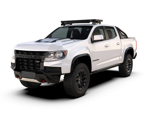 Alt text: "White Chevrolet Colorado ZR2 equipped with Front Runner Slimline II Roof Rack Kit for Cab Over Camper, 2nd Generation model years 2015-2022, on a white background."