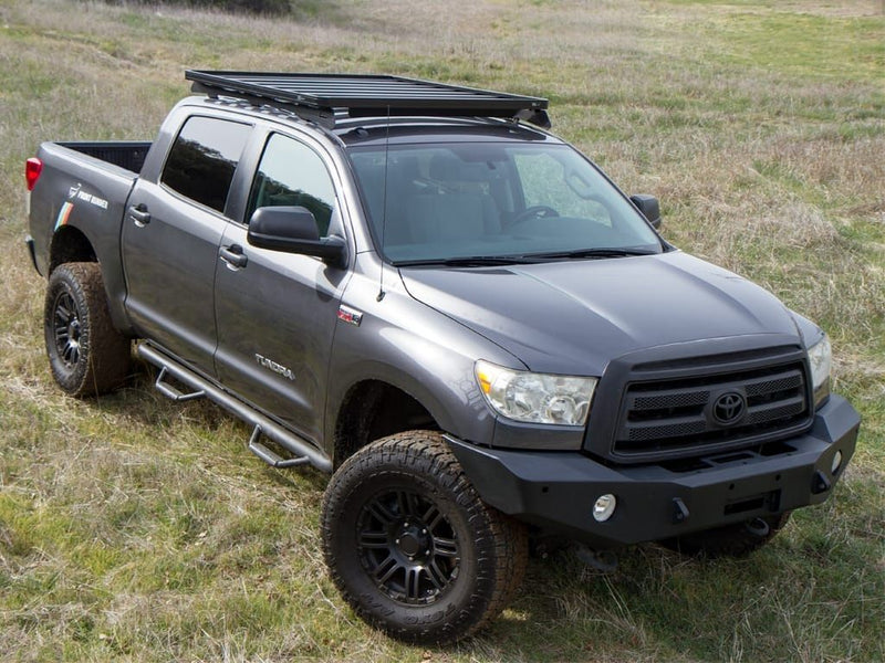 Load image into Gallery viewer, Toyota Tundra Crew Max with Slimline II Roof Rack Kit by Front Runner mounted on top in a low profile setup, parked outdoors.
