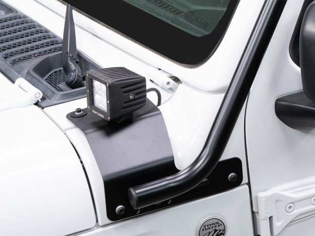 Load image into Gallery viewer, Close-up of Front Runner Slimline II Roof Rack Kit installed on a white Jeep Wrangler JL 4 Door, showing sturdy mount and auxiliary light.
