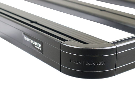 Close-up of Front Runner Slimline II roof rack kit for Land Rover Defender 130 with visible logo and black finish.