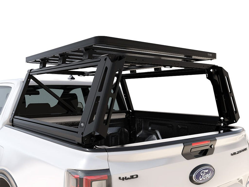 Load image into Gallery viewer, Alt text: &quot;Front Runner Pro Bed Rack Kit installed on a 2022 Ford Ranger T6.2 Wildtrak/Raptor Double Cab pickup truck, featuring sturdy black rack frames on truck bed.&quot;
