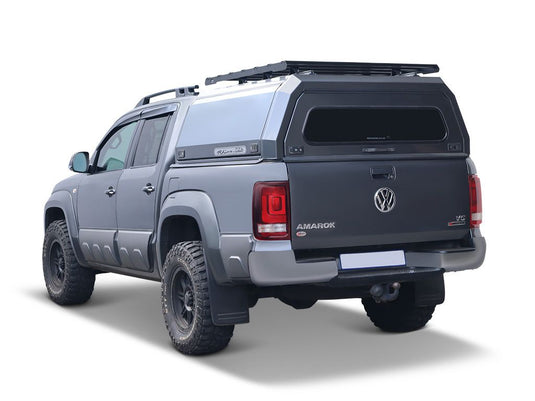 Alt text: "Rear view of Volkswagen Amarok pickup truck equipped with Front Runner Slimsport Rack Kit on load bed canopy."