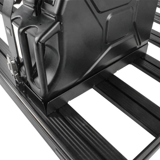 Front Runner Single Jerry Can Holder securely mounted on black roof rack, close-up view on detail and latch mechanism.