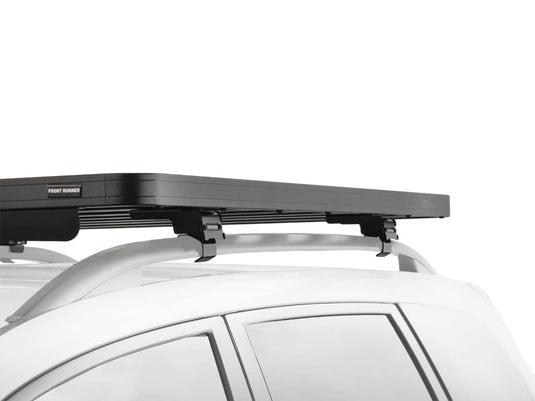 Front Runner Slimline II Roof Rack mounted on a white Jeep Grand Cherokee, model years 1999 to 2010, showing detail of the roof rail rack kit.