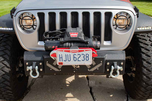 Alt text: "Fishbone Offroad Barracuda Modular Bumper on a Jeep Wrangler, featuring a winch and tow hooks, perfect for JK, JKU, JL, JLU, and Gladiator JT models."