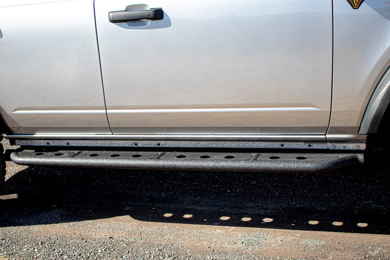 Load image into Gallery viewer, Alt text: &quot;Fishbone Offroad step sliders installed on a 2022 Ford Bronco, enhancing vehicle&#39;s side profile with rugged design.&quot;
