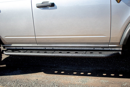 Alt text: "Fishbone Offroad step sliders installed on a 2022 Ford Bronco, enhancing vehicle's side profile with rugged design."