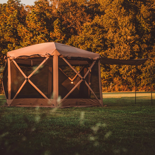 Gazelle Tents G6 Deluxe 6-Sided Portable Gazebo set up in an outdoor setting at sunset