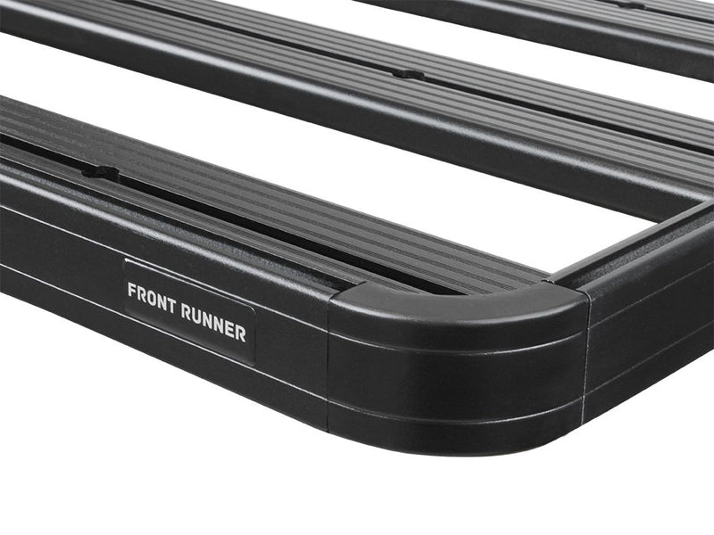 Load image into Gallery viewer, Close-up of Front Runner Slimline II Roof Rack Kit for Toyota 100 Series Land Cruiser or Lexus LX470, showcasing the sturdy black aluminum build and the engraved Front Runner logo.
