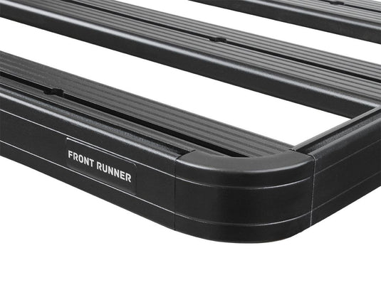 Close-up of Front Runner Slimline II Roof Rack Kit for Toyota 100 Series Land Cruiser or Lexus LX470, showcasing the sturdy black aluminum build and the engraved Front Runner logo.