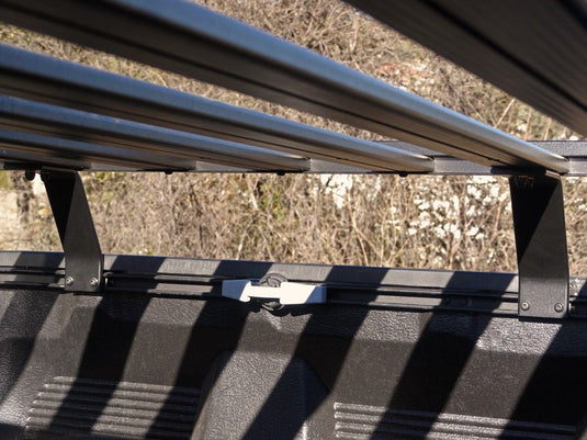 Close-up of the Front Runner Slimline II Load Bed Rack Kit installed on a Toyota Tundra Crew Max Truck, highlighting the durable construction and secure mounting system.