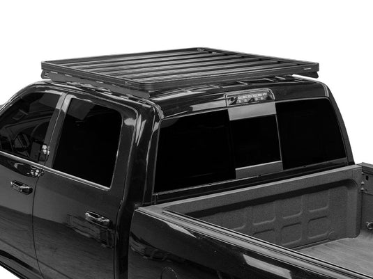 Low profile Slimline II Roof Rack Kit installed on Ram 1500 Crew Cab, compatible with 2009-Current 2500 and 3500 models.