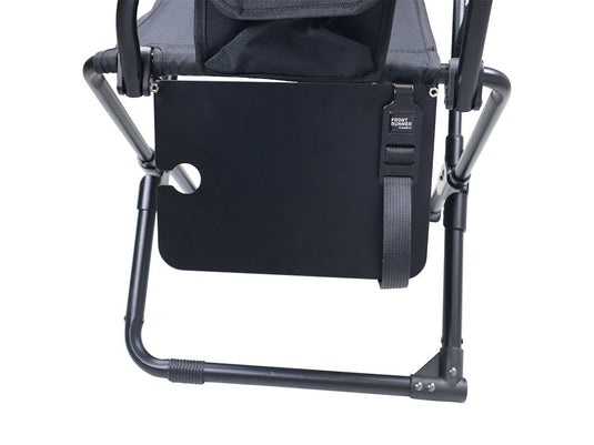 Alt text: "Close-up view of the black Front Runner Expander Chair Side Table attached to a camping chair with logo visible."