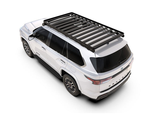 2022 Toyota Sequoia with Front Runner Slimline II Roof Rack Kit installed, showing durable black metal rack on a white SUV for enhanced cargo capacity.