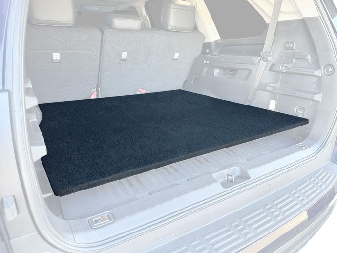 Front Runner Base Deck fitted in the cargo area of a 2023 Toyota Sequoia, showcasing the custom fit and sleek black design.