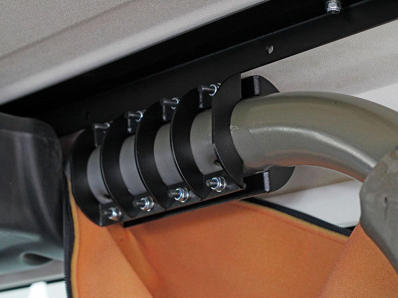 Load image into Gallery viewer, Close-up installation view of the Front Runner Extreme Roof Rack Kit brackets on a Jeep Wrangler JK 2 Door (2007-2018)
