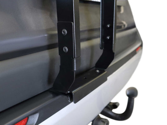 Alt text: "Close-up view of a black Front Runner ladder attached to a silver Toyota Rav4, model years 2019-current, highlighting the sturdy mounting and sleek design."