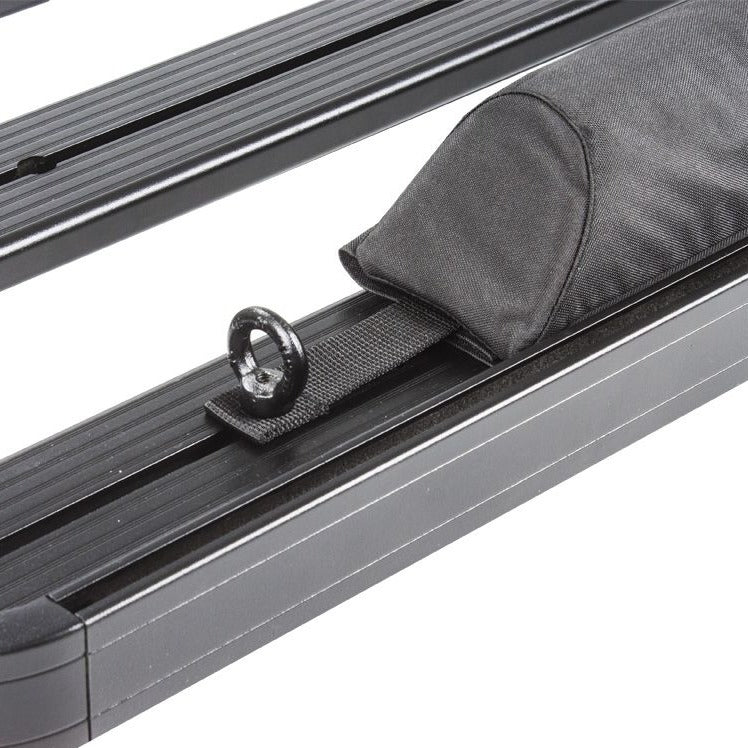 Load image into Gallery viewer, Close-up of a Front Runner Rack Pad Set on a vehicle roof rack, showcasing the durable fabric and secure strap design.
