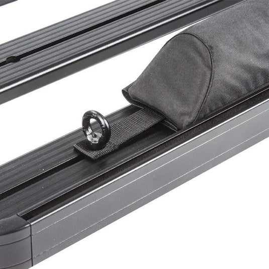 Close-up of a Front Runner Rack Pad Set on a vehicle roof rack, showcasing the durable fabric and secure strap design.