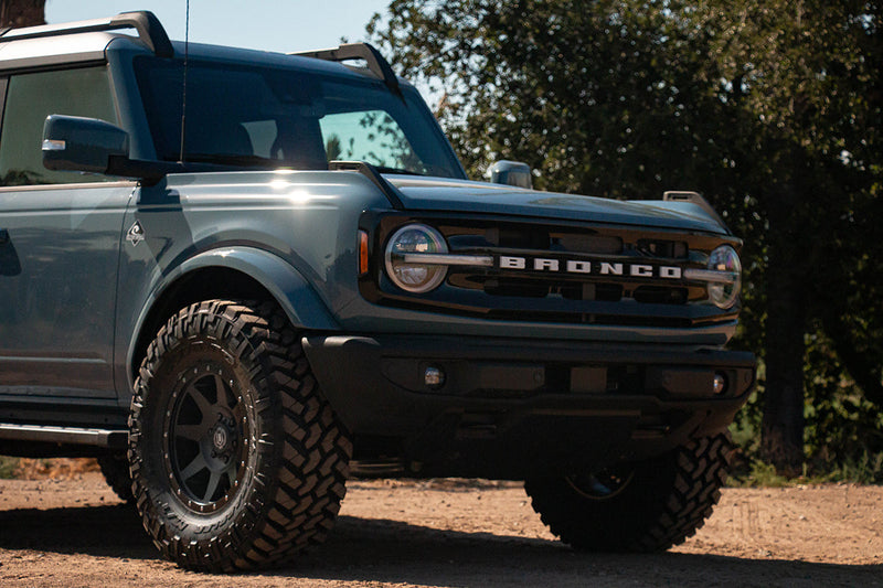 Load image into Gallery viewer, Blue Ford Bronco with ICON Vehicle Dynamics Rebound wheels in satin black finish
