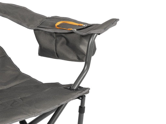"Close-up view of the durable fabric and armrest of a Front Runner Dometic Duro 180 Folding Chair with zipper pocket detail."