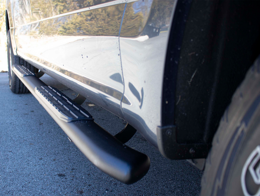 Alt text: "Close-up view of Fishbone Offroad 5 Inch Oval Side Steps installed on 2015-2023 Ford F-Series SuperCrew Cab."